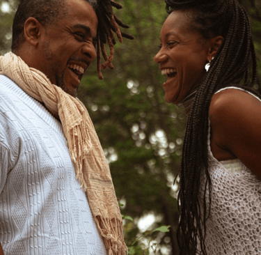a man and woman smiling and laughing