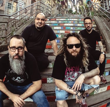a group of men sitting on stairs with a man with a beard
