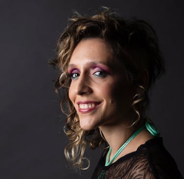 a woman with a black top and a green necklace