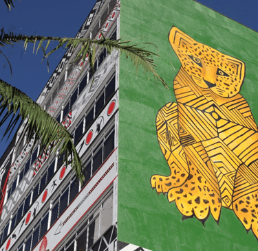 a large green and yellow mural of a leopard