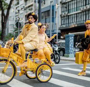 a man in a yellow outfit is riding a bicycle
