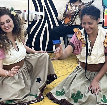 two women in costumes and costumes are sitting on the floor