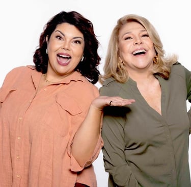 two women standing next to each other holding hands