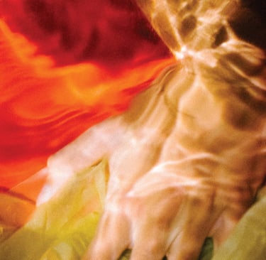 a person's hand holding a piece of art