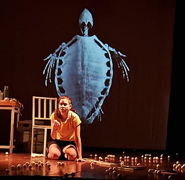 a woman sitting on a stage with candles and candles