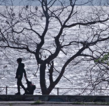 a man walking down a sidewalk with a dog