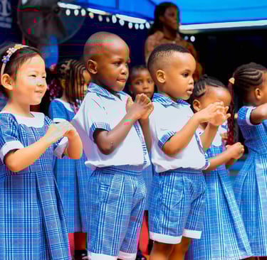 A group of confident students presenting on stage at a school assembly, with parents in attendance.