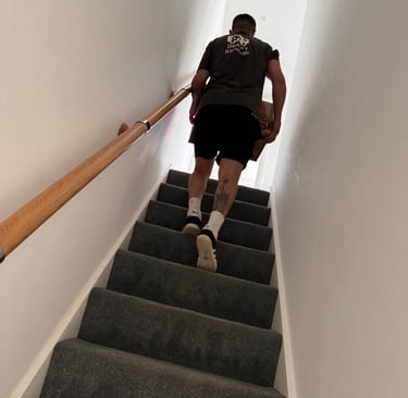 man carrying box up stairs