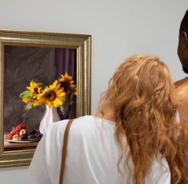 a man and woman looking at a painting of a sunflower