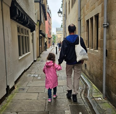 Dad and daughter walking in Oxford after packing rain jackets and a layered capsule wardrobe