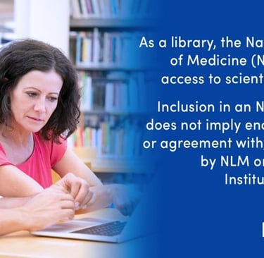 a man and woman sitting at a table with a laptop