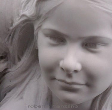 Hand-carved white marble bust sculpture featuring the realistic portraits of a young boy and girl.
