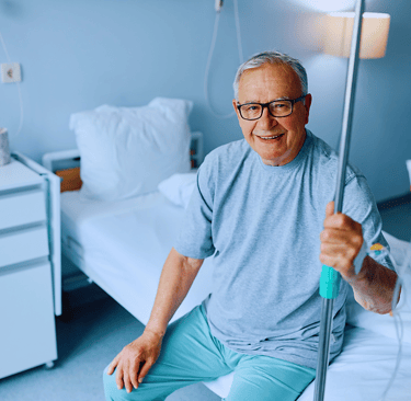 Elderly man receiving IV energy boosting therapy to improve his strength and vitality. Advanced hydr