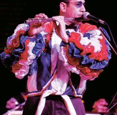 Maestro Bobby Ramirez playing flute in cuban style rumba Show attire