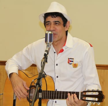 Maestro Bobby Ramirez playing guitar and singing Cuban music