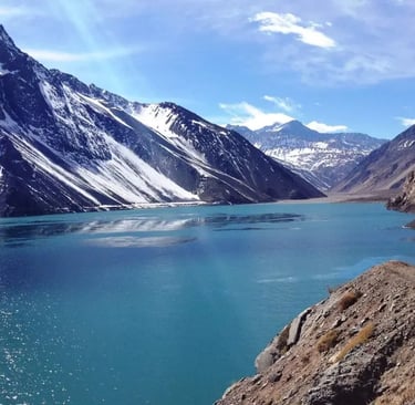 a mountain scene with a lake and mountains in the background