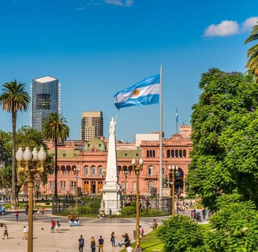 a city square with palm trees and a flag