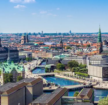 a cityscape of a city with a river and a bridge