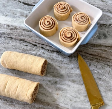a knife and cinnamon rolls proofing