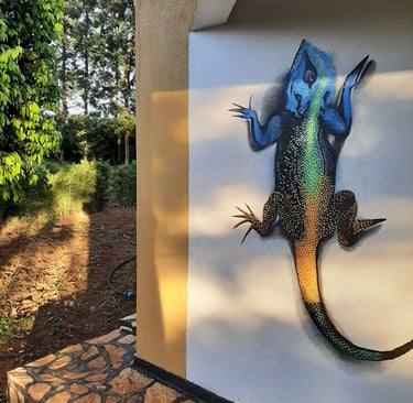 a photograph of an agama lizard painted on a wall.