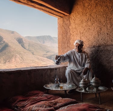 Moroccan Bedouin in the atlas desert behind argan tree 