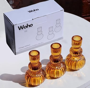 Set of three amber ribbed glass candlestick holders with box packaging labeled Woho