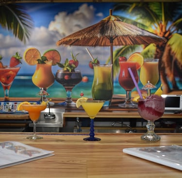 Tropical drinks on a bar with image of Tropical drinks behind it.