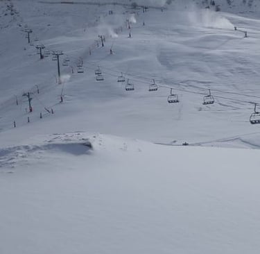 a person skiing down a snowy mountain slope