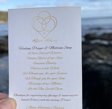 Sacred Water Prayer card held against the Cornish coast for Reiki master training.
