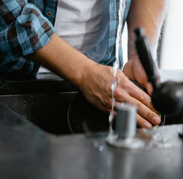 a man is washing his hands in a sink