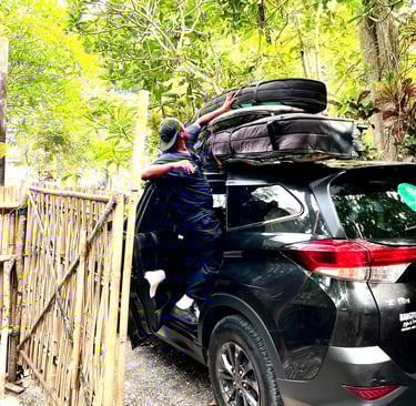 Ucup putting surfboards on car to Batukaras