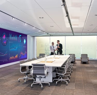 Modern conference room with data analytics wall display and professionals meeting.