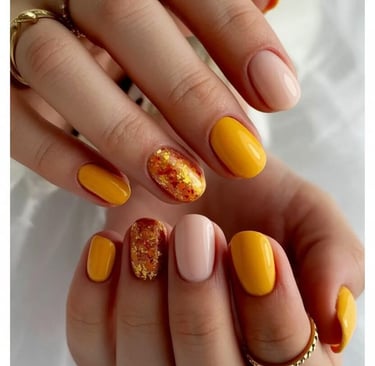 Mustard yellow and beige nails with glitter foil and autumn leaf design – vibrant and trendy fall na