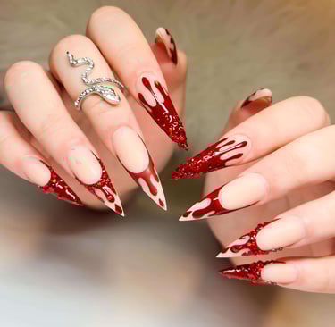 Stiletto fall nails with red blood-drip design and red crystal accents.