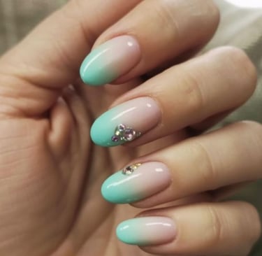 Sage green nails with neutral base and black leaf outlines finished with glitter tips – botanical in