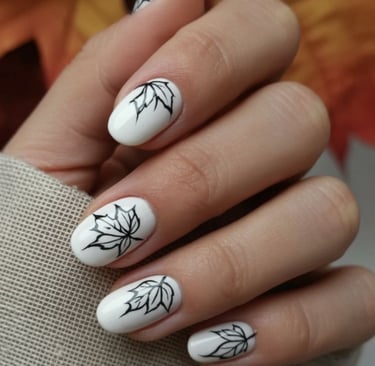 Short white fall nails with black botanical line art on accent nails.