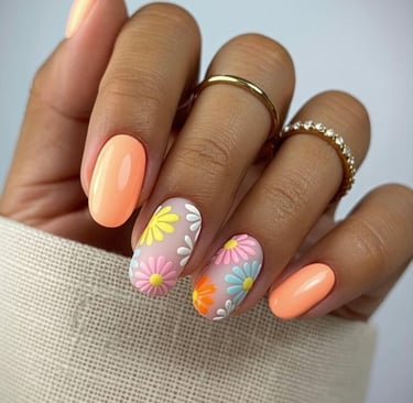 Neon peach nails with 3D pastel daisies