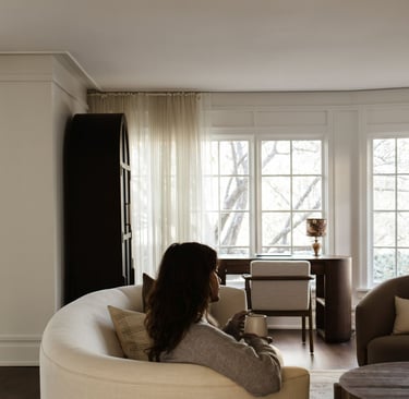 Bright narrow living room with floating sofa layout, sofa pulled away from wall, airy and inviting S