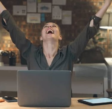 joyful woman behind her laptop