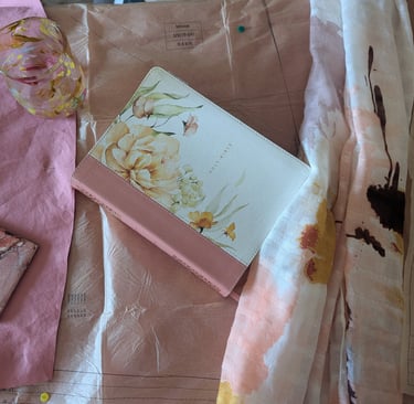 An image of the Holy Bible around fabric and sewing pattern. Connecting faith and creativity.