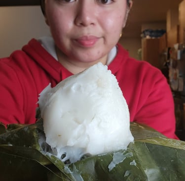 a woman holding a large piece of food in her hands