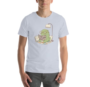 A man wearing a light blue t-shirt with a graphic of a cute dinosaur reading a book.