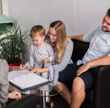 a family sitting on a couch in a living room