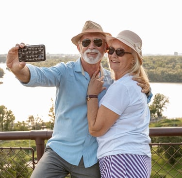 a man and woman taking a selfie with a cell phone