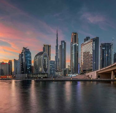 Dubai skyline at sunset with Burj Khalifa and Business Bay towers, representing global investors and family office access.