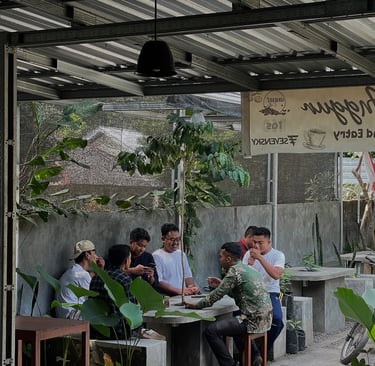 a group of people sitting at a table with food
