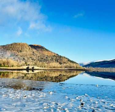 Loch Fyne in Inveraray with the Inveraray bridge and hills in the backgound.