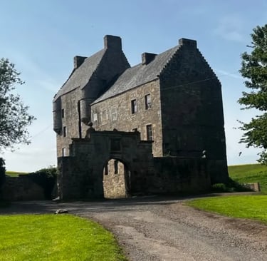 a large stone building with a large stone archway to the front
