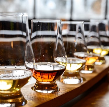 a row of glasses with different types of whisky