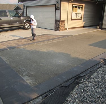 Crushed rock is spread, and compacted.